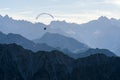 Paraglider flying above blue Mountains Silhouette, Allgaeu, Oberstdorf, Alps, Germany. Travel destination. Freedom and Royalty Free Stock Photo