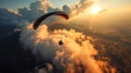 Paraglider flying in the blue sky with clouds at sunset