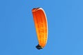 Paraglider flying in a blue sky Royalty Free Stock Photo