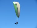 Paraglider flying in the blue sky in Piedrahita, Spain.