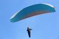 Paraglider flying in a blue sky Royalty Free Stock Photo