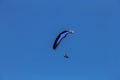 Paraglider flying against the blue sky Royalty Free Stock Photo