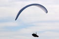 Paraglider flying in a cloudy sky Royalty Free Stock Photo