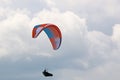 Paraglider flying in a cloudy sky Royalty Free Stock Photo
