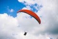 Paraglider flying in cloudy sky Royalty Free Stock Photo