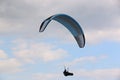 Paraglider flying in a cloudy sky Royalty Free Stock Photo