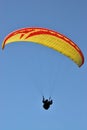 A paraglider flying free in the blue skies