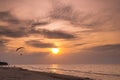 Paraglider flying over the beach