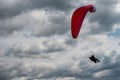 Paraglider flying over cloudy sky Royalty Free Stock Photo