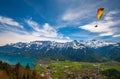 Paraglider flying over mountains at sunny summer day, Interlaken, Swiss Alps Royalty Free Stock Photo