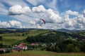 Paraglider flying over mountains during summer day Royalty Free Stock Photo