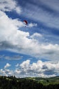 Paraglider flying over mountains during summer day Royalty Free Stock Photo