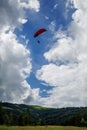 Paraglider flying over mountains during summer day Royalty Free Stock Photo