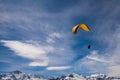Paraglider flying over mountains at sunny summer day, Swiss Alps Royalty Free Stock Photo