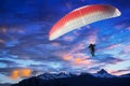 Paraglider flying over mountains in sunset Royalty Free Stock Photo