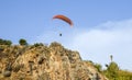 Paraglider flying over the rock in the Antalya, Turkey. Active lifestyle, extreme sport.