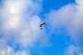 Paraglider flying over sea. Paraglider flies colorful paraglider in the blue sky. Royalty Free Stock Photo