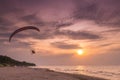 Paraglider flying over the beach