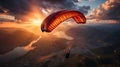 Paraglider flying in the sky above the city at sunset