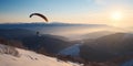 paraglider flying in the sky over there Snowy Mountain against winter Valley