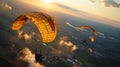 Paraglider flying in the sunset sky in yellow parachute