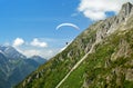 Paraglider flys in the mountains Royalty Free Stock Photo