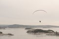 Paraglider gliding over an icy fjord.. Royalty Free Stock Photo