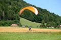 Paraglider landing in a field