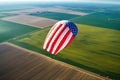 Paraglider made from the American flag flying over the field Royalty Free Stock Photo