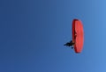 Paraglider and a passenger on a red paraglider with a motor are flying Royalty Free Stock Photo