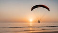 Paraglider pilot flies in the sky during sunset on beautiful beach. Paraplane .