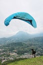 Paraglider pilot flying after taking off from hill Royalty Free Stock Photo