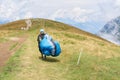 Paraglider pilot with his paraglider on his way to the top of Monte Baldo on Lake Garda Royalty Free Stock Photo