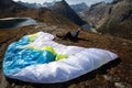 Paraglider Pilot sits with his paraglider on the ground and recovers after ground handling Royalty Free Stock Photo