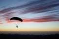 Paraglider pilot on sunset