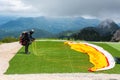 Paraglider preparing a launch in mountainous area near Fussen, Germany