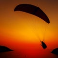 Paraglider silhouette against the background of the sunset sky Royalty Free Stock Photo