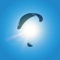 Paraglider silhouette in blue sunny sky Royalty Free Stock Photo
