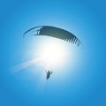 Paraglider silhouette in blue sunny sky Royalty Free Stock Photo