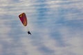 Paraglider soaring above clouds during daytime flight Royalty Free Stock Photo