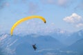 Paraglider soaring in the blue sky over the beautiful mountains. Royalty Free Stock Photo