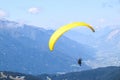 Paraglider soaring in the blue sky over the beautiful mountains. Royalty Free Stock Photo