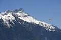 Paraglider soaring in front of snow-capped peaks of the Valais Alps Royalty Free Stock Photo