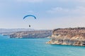Paraglider soaring over the cliffs of Kurion and mediterranean s