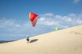 Paraglider soars, starts, on the dune of a beach Royalty Free Stock Photo