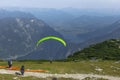 A paraglider at the start of the Krippenstein mountain in the Dachstein area,Austria.Paraglide silhouette over Hallstatter See.