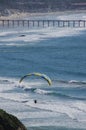 Paraglider, surfers, swimmers near Scripps Pier, La Jolla, California Royalty Free Stock Photo