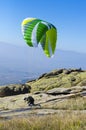 Paraglider takes off from a mountain peak