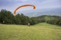 Paraglider taking off from the edge of the mountain Royalty Free Stock Photo