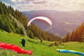 Paraglider taking off in front of spectacular mountain scenery Royalty Free Stock Photo